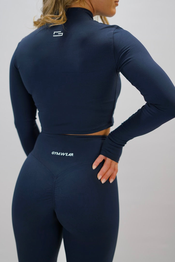 Marinblå Zoe Cropped Zip-up Top - cropped långärmad tröja med dragkedja, tumhål, Gymwear-logga på vänster axel och G-symbol i nacken