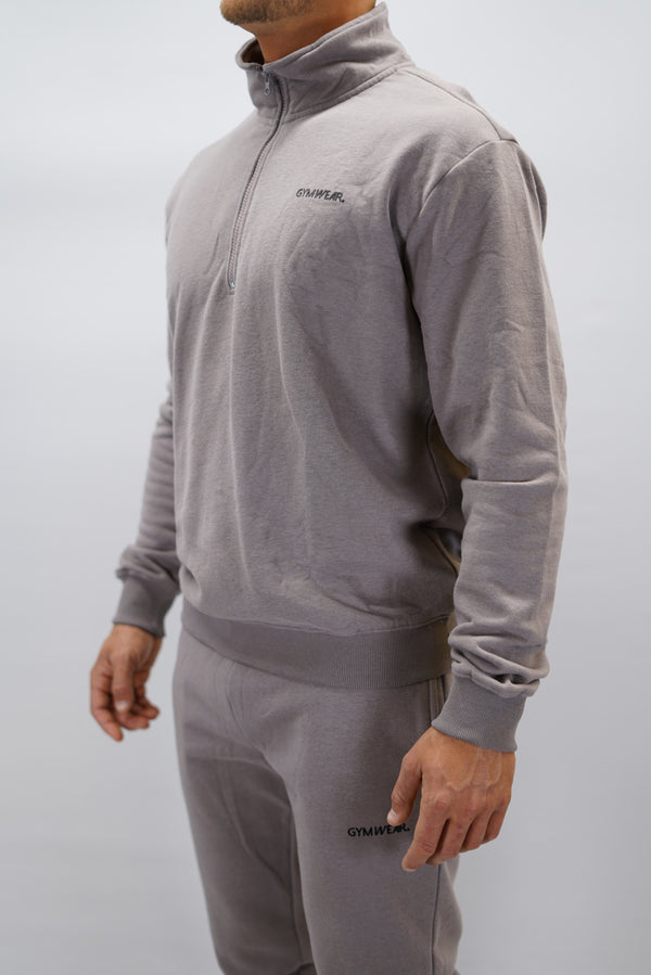 Half-Zip Sweater för herr i mjuk borstad bomull, zink färg, med Gymwear logga på vänster bröst och symbol G i nacken. Stilren och funktionell tröja för vardag och aktivitet.