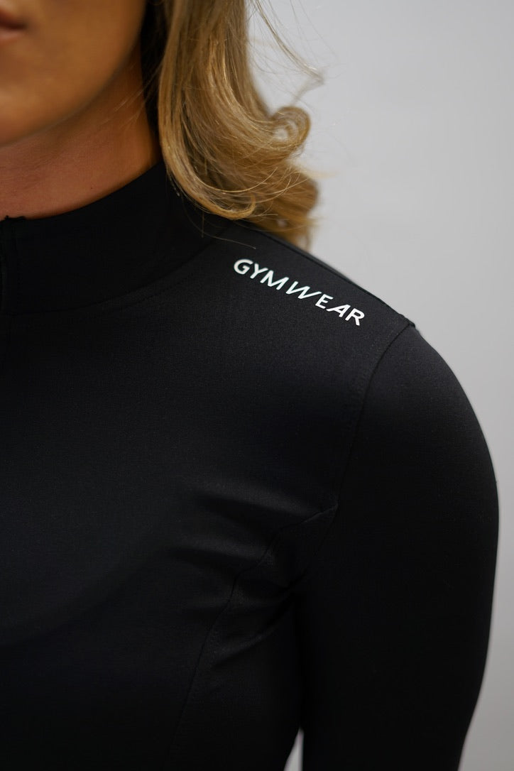 Svart Zoe Cropped Zip-up Top - cropped långärmad tröja med dragkedja, tumhål, Gymwear-logga på vänster axel och G-symbol i nacken