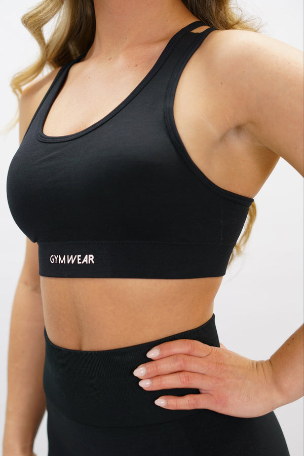 Blå Naima Premium Sport Bra - premium sport-bh med axelsnören och korsade band på ryggen, Gymwear-logga på framsidan